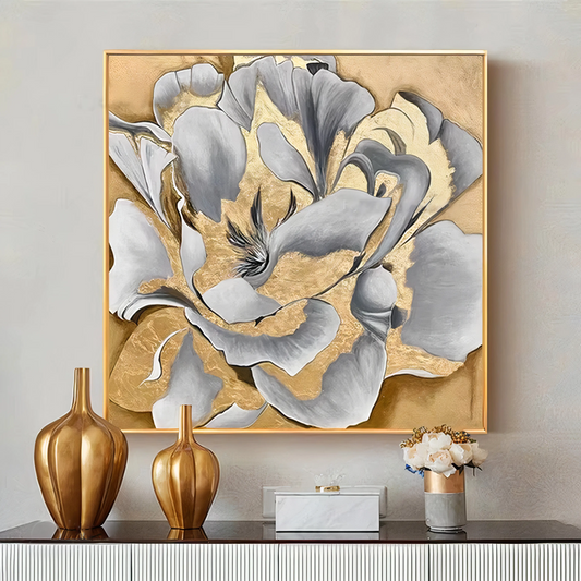 Decorative wall art with floral design on a gold background, displayed on a wall with matching vases and decor.